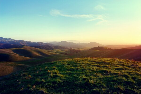 Grassy hills with the setting sun