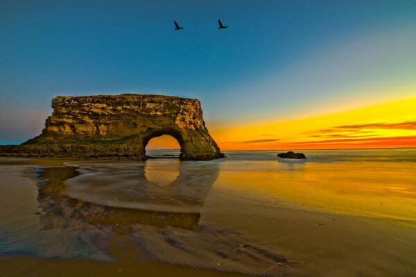 The sea coast with a rock in the form of an arch