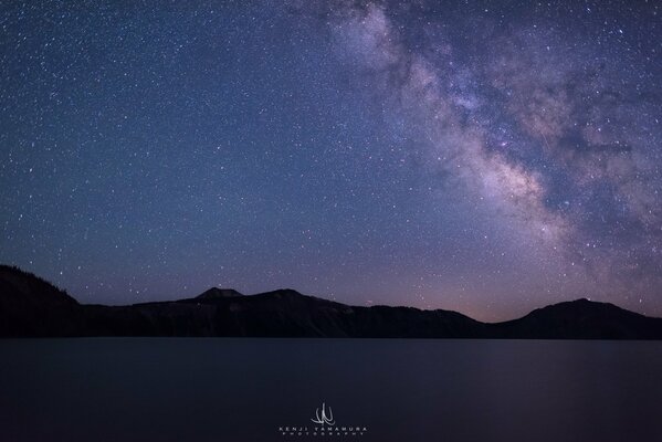 Night lake on the background of the starry sky