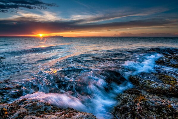 Sunset on the horizon of the seething sea