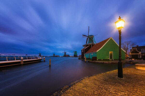 Iluminación nocturna linterna y casa verde junto al río