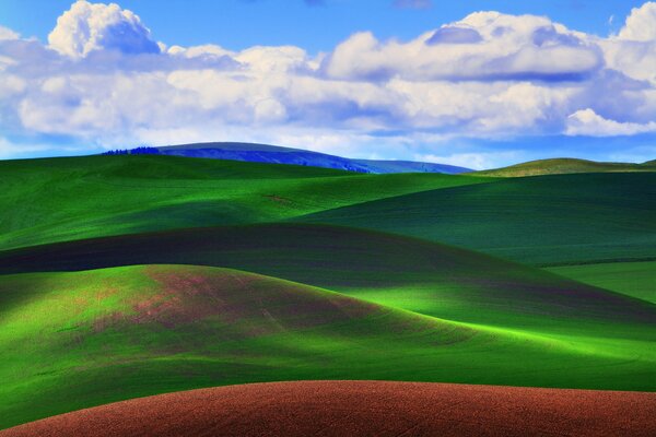 Blue clouds on the background of hills