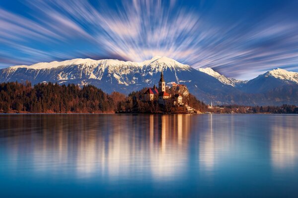 Nature of Slovenia. Temple on the background of mountains, forests and lakes