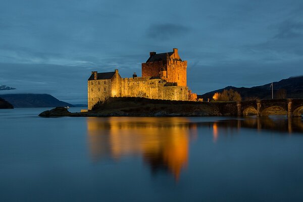 Evening lighting of the castle on the lake