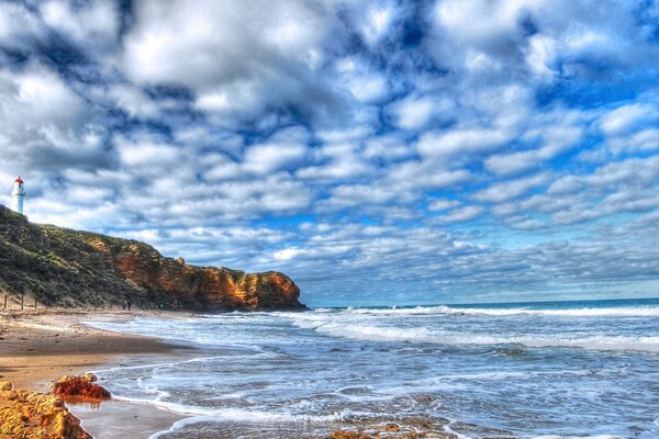 The lighthouse stands on a promontory near the sea