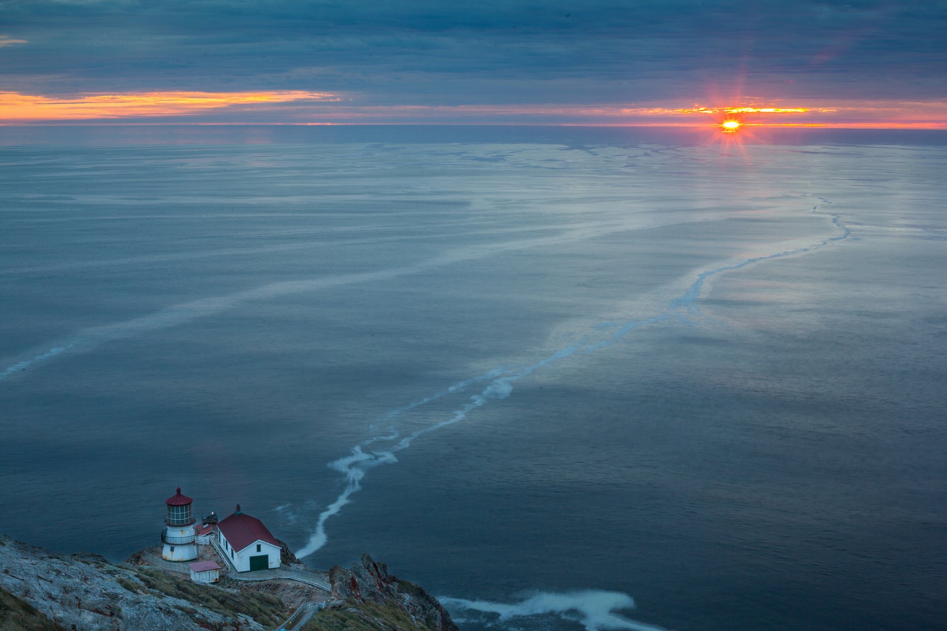 unset sea lighthouse landscape