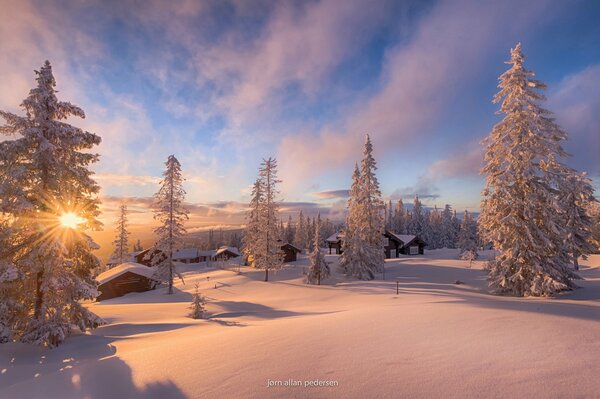 Winter in Norway, houses are hidden under snow and sunlight