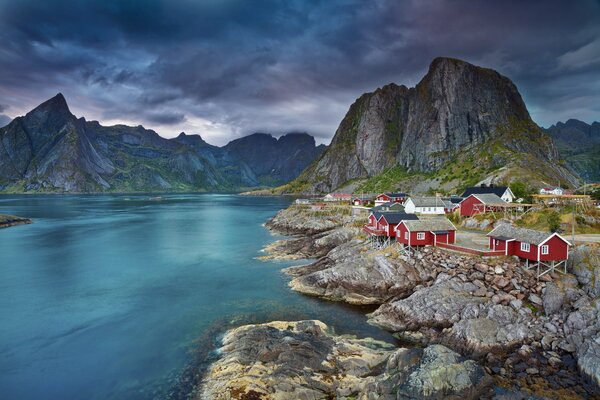 Houses at the foot of the mountains in Norway. Red houses in the mountains