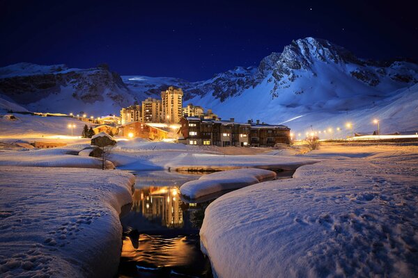 Cottage town at the foot of the mountains at night