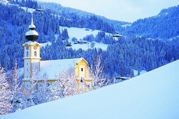 Chiesa con l orologio sulla montagna in inverno