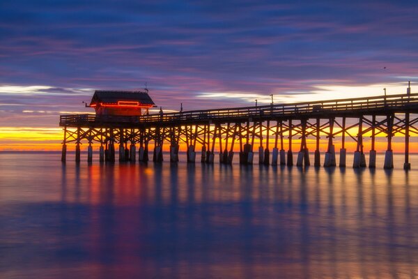 Pier and house on the seashore