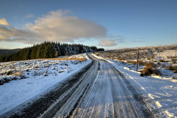 Winter road through a snowy valley