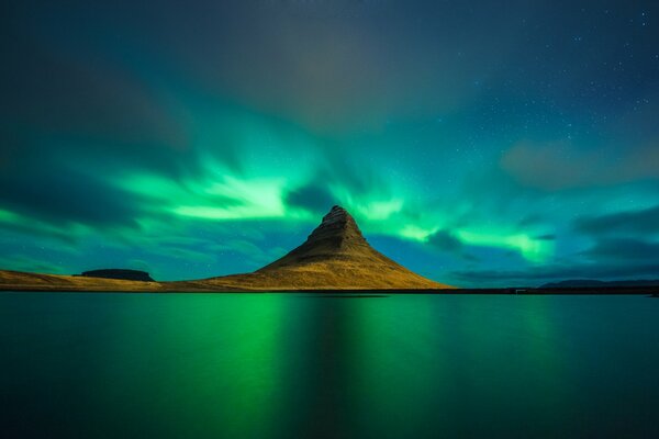 The Northern lights are reflected in the water