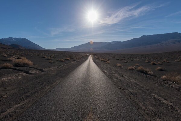 Asphalt road in the steppe to the mountains