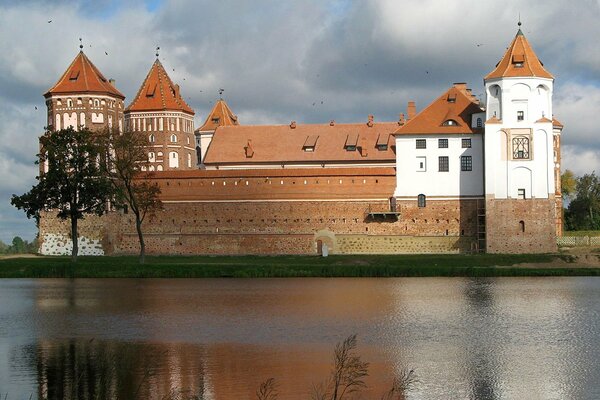 A house with towers on the river bank