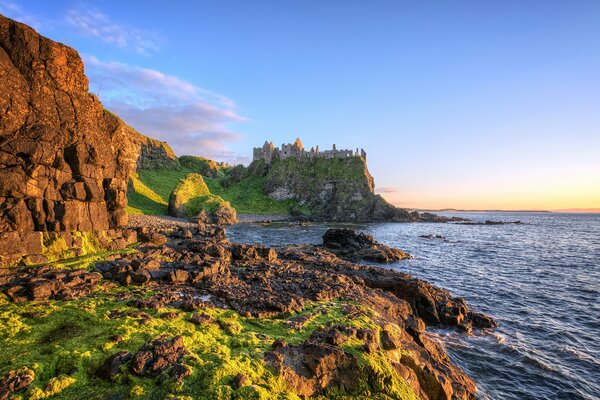 Castle on a rocky cliff overlooking the sea Stone