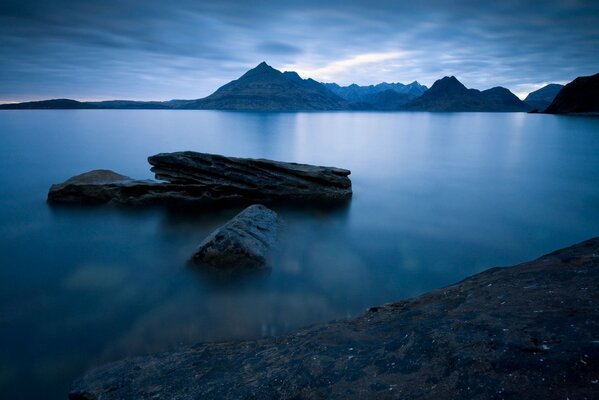 Night coast against the background of mountains