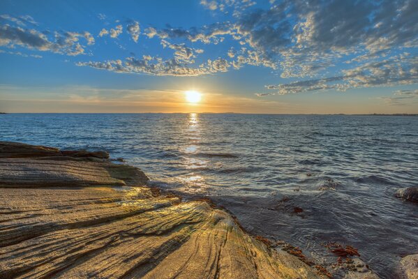 Una cálida puesta de sol en la costa rocosa