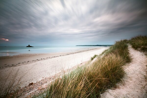 Evening empty beach in cloudy weather