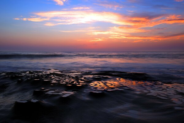 Sunset over the sea and rocks