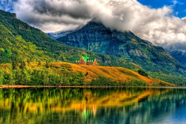 A lonely house on the shore is reflected in the lake