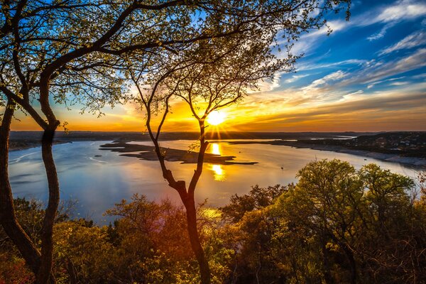 Sun and clouds over a lake in Texas