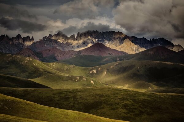 Paisaje con cordillera y colinas. Cielo nublado con nubes