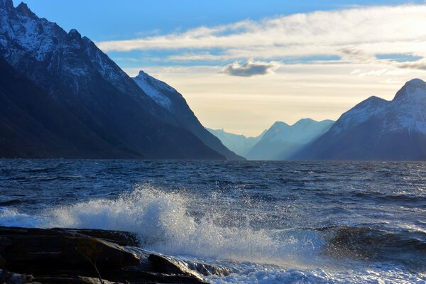 High mountains, clouds and the sea. Water splashes