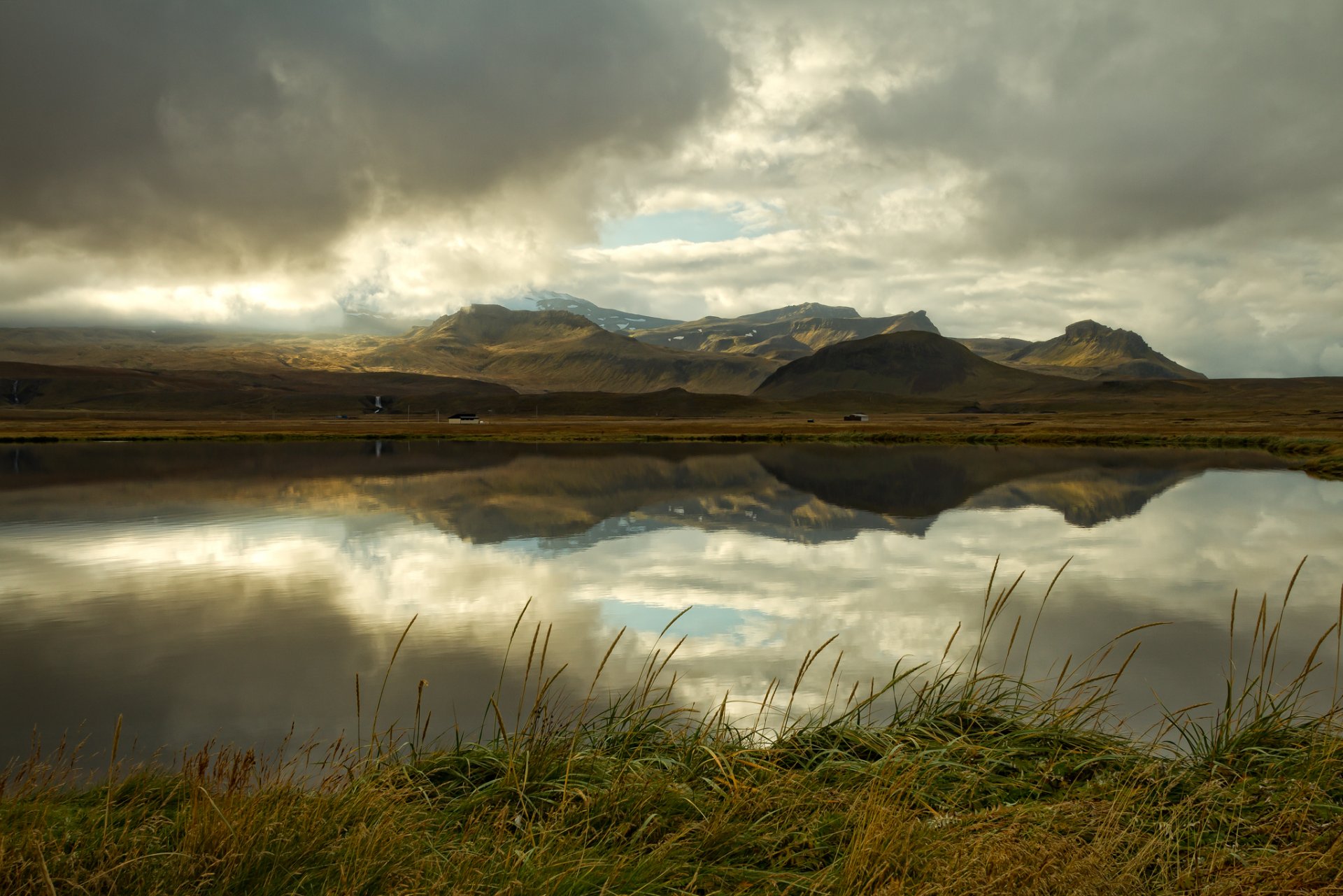 iceland mountain lake clouds reflection