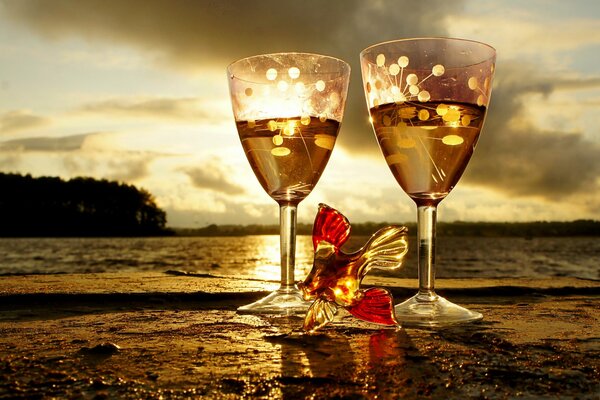 Fish figurine at sunset near glasses