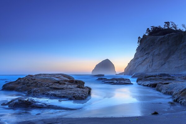 Landscape of ocean and rocks at sunset