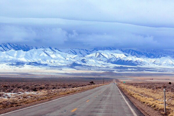 The road to the snow-capped peaks of the mountains