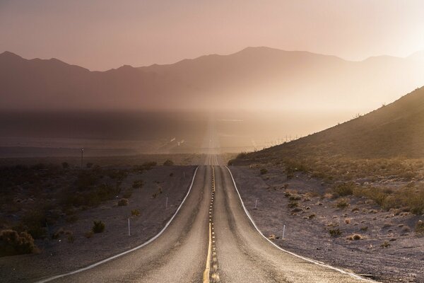 Morning road in the first rays of the sun