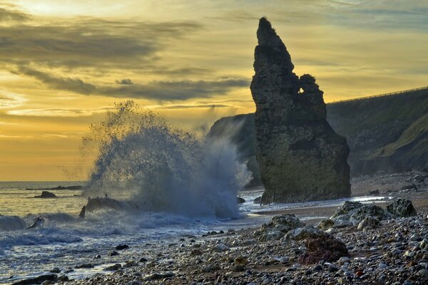 Sea spray under a lonely rock