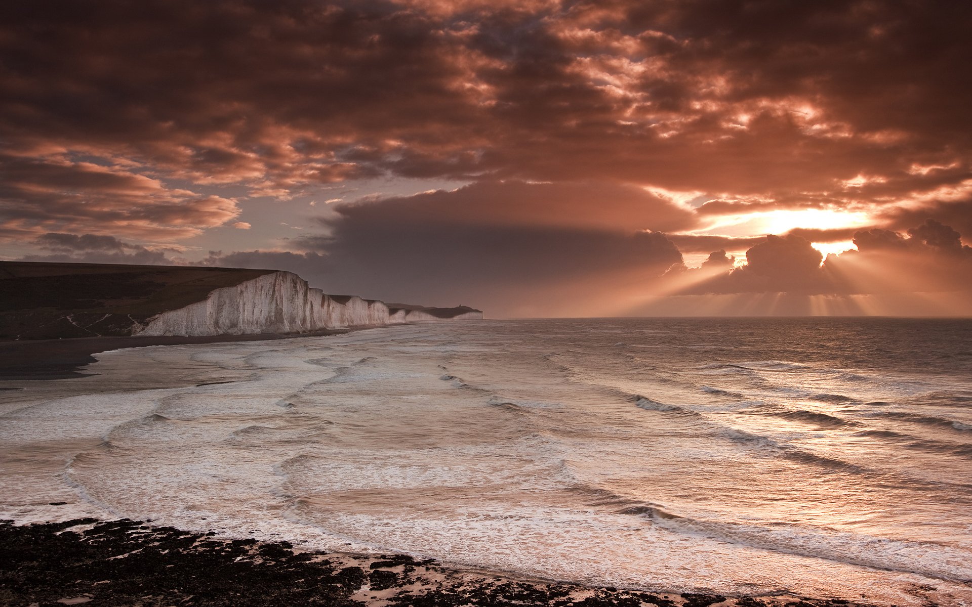 coast rock waves sky clouds light