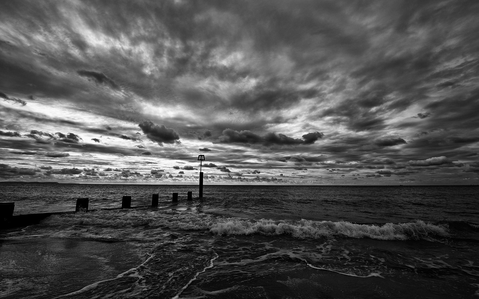 beach water waves sky clouds horizon black and white