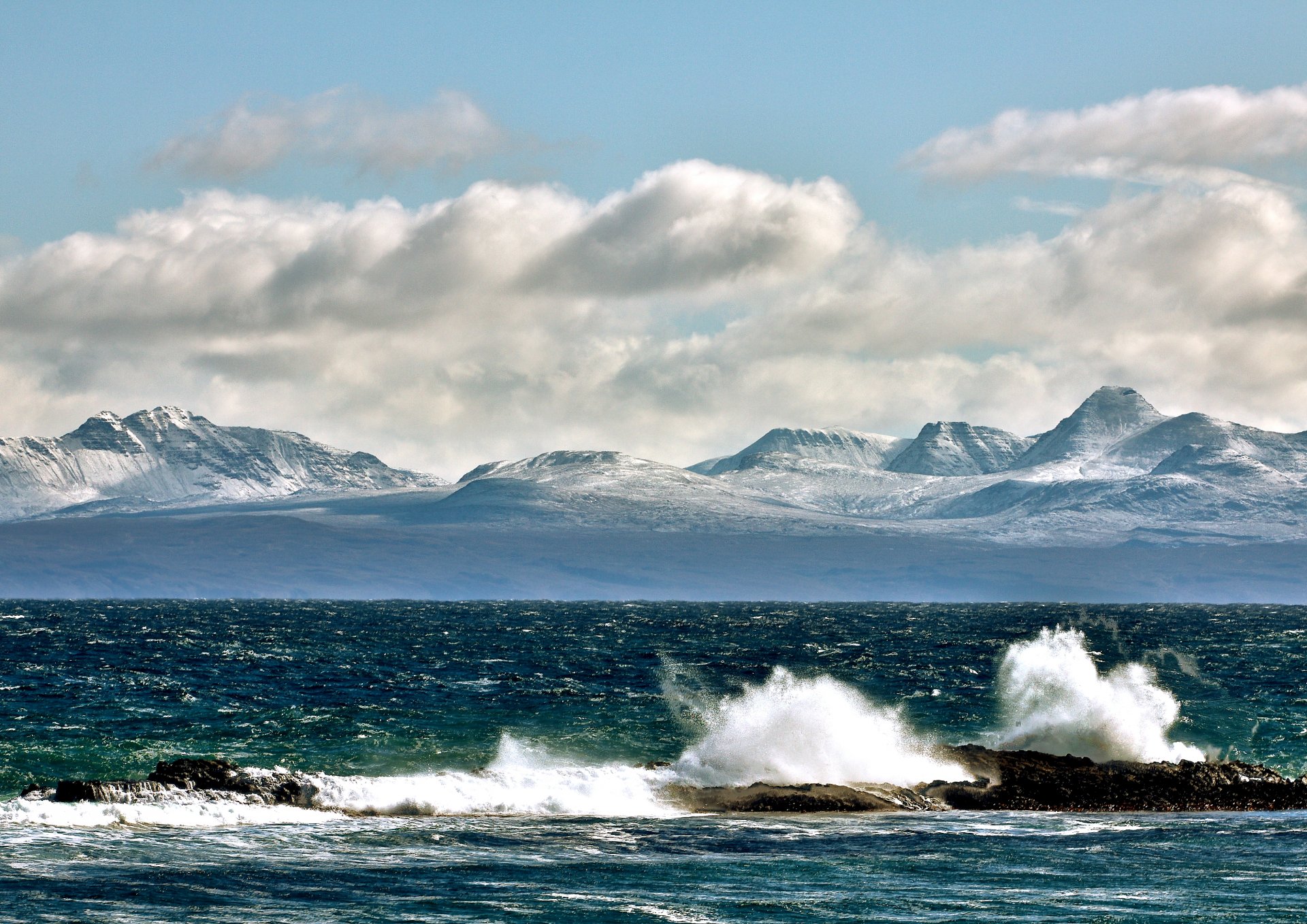 gulf waves stones spray mountain tops sky cloud