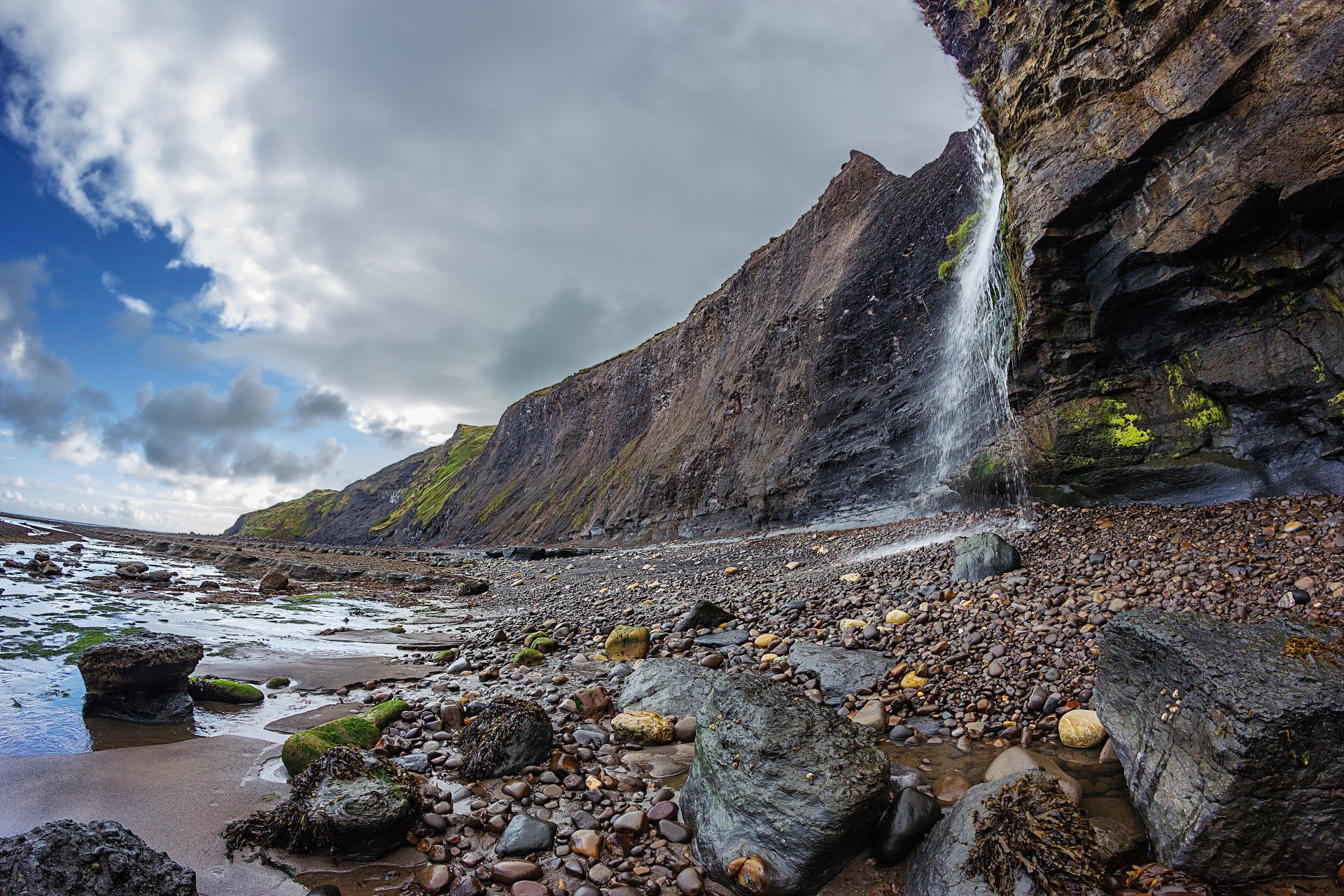 beach stones rock waterfall sky cloud