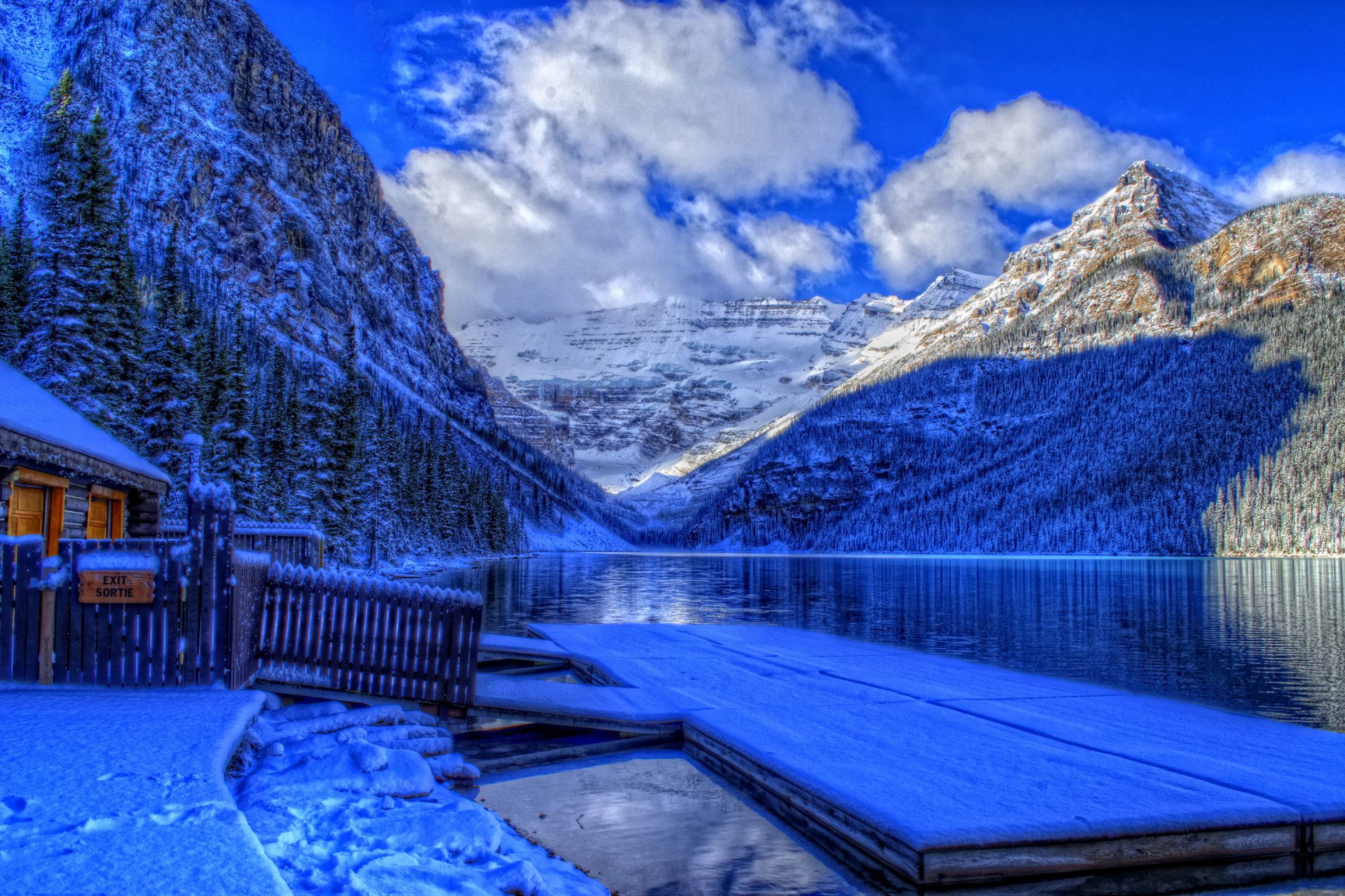 banff national park alberta canada winter snow lake mountain sky clouds forest tree house pier