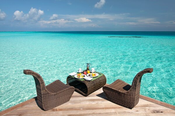 Romantic picnic on the pier by the ocean