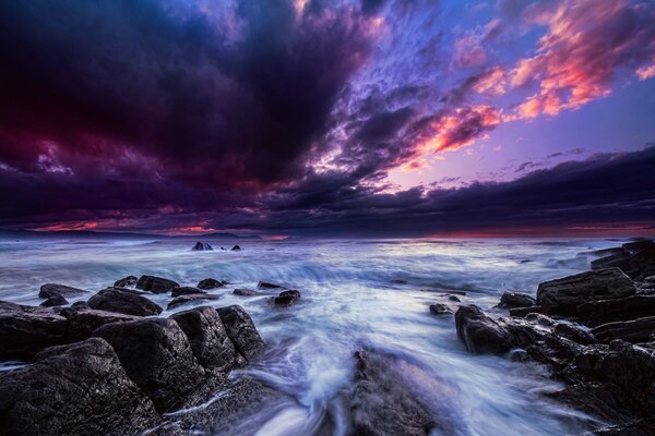 A horizon of sea and black clouds