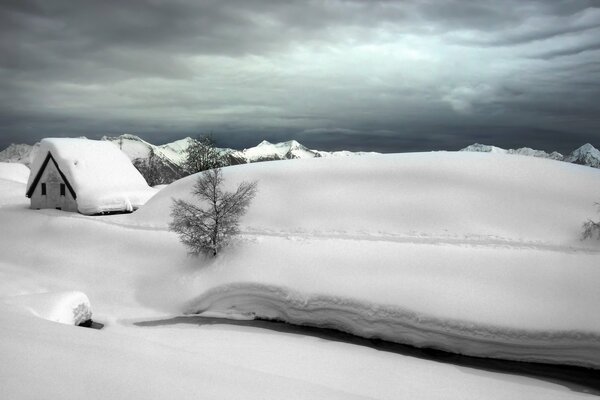 Winter in the village. Lush drifts of snow