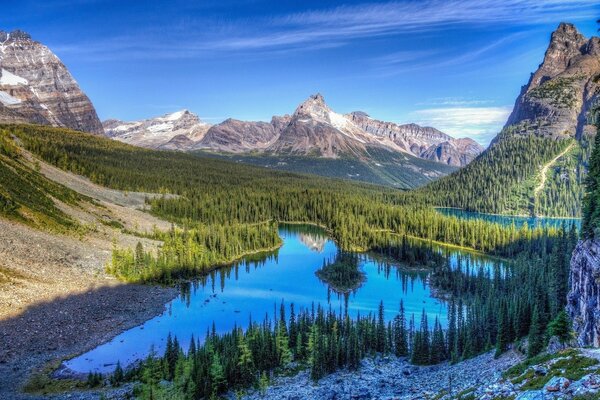 A quiet lake along forests and rocks