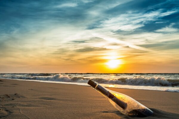 A bottle brought by the sea on the shore