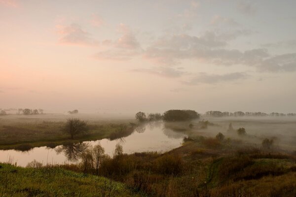 Fog in the field over the river