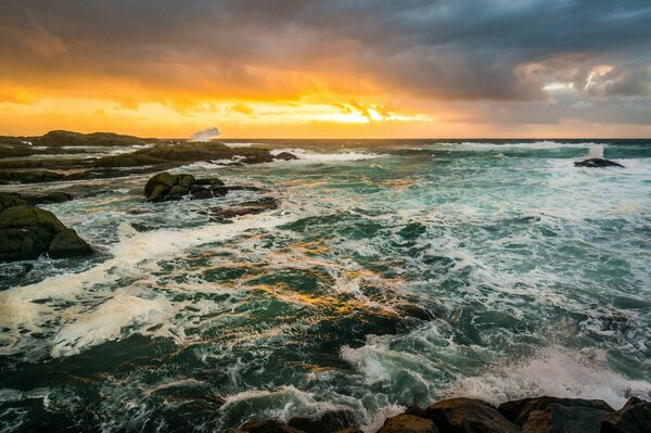 The sea waves beat against the rocks