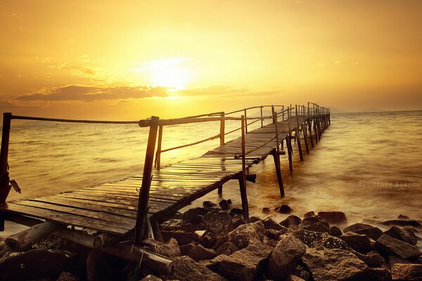 Bridge to the sea at sunset