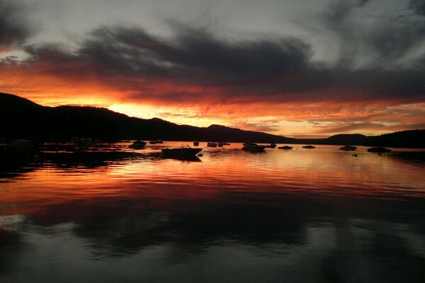 Bright sunset in the sky over the lake