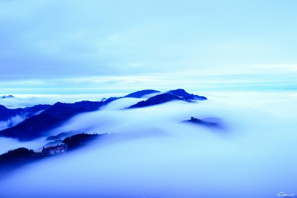 Houses on cloudy hilltops