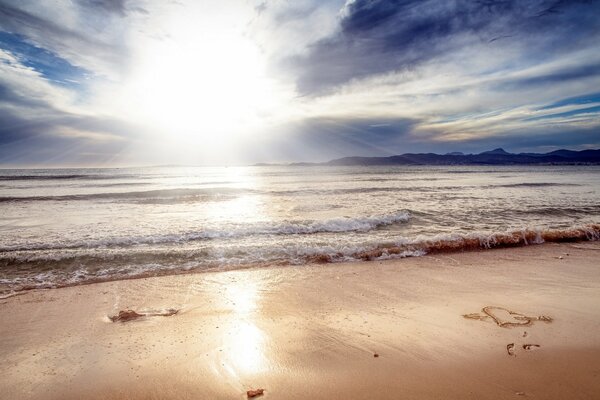 Heart on the sand of the morning seashore